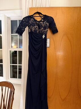 Betsy and Adam Navy Lace Illusion Sleeve Evening Gown with Side Brooch